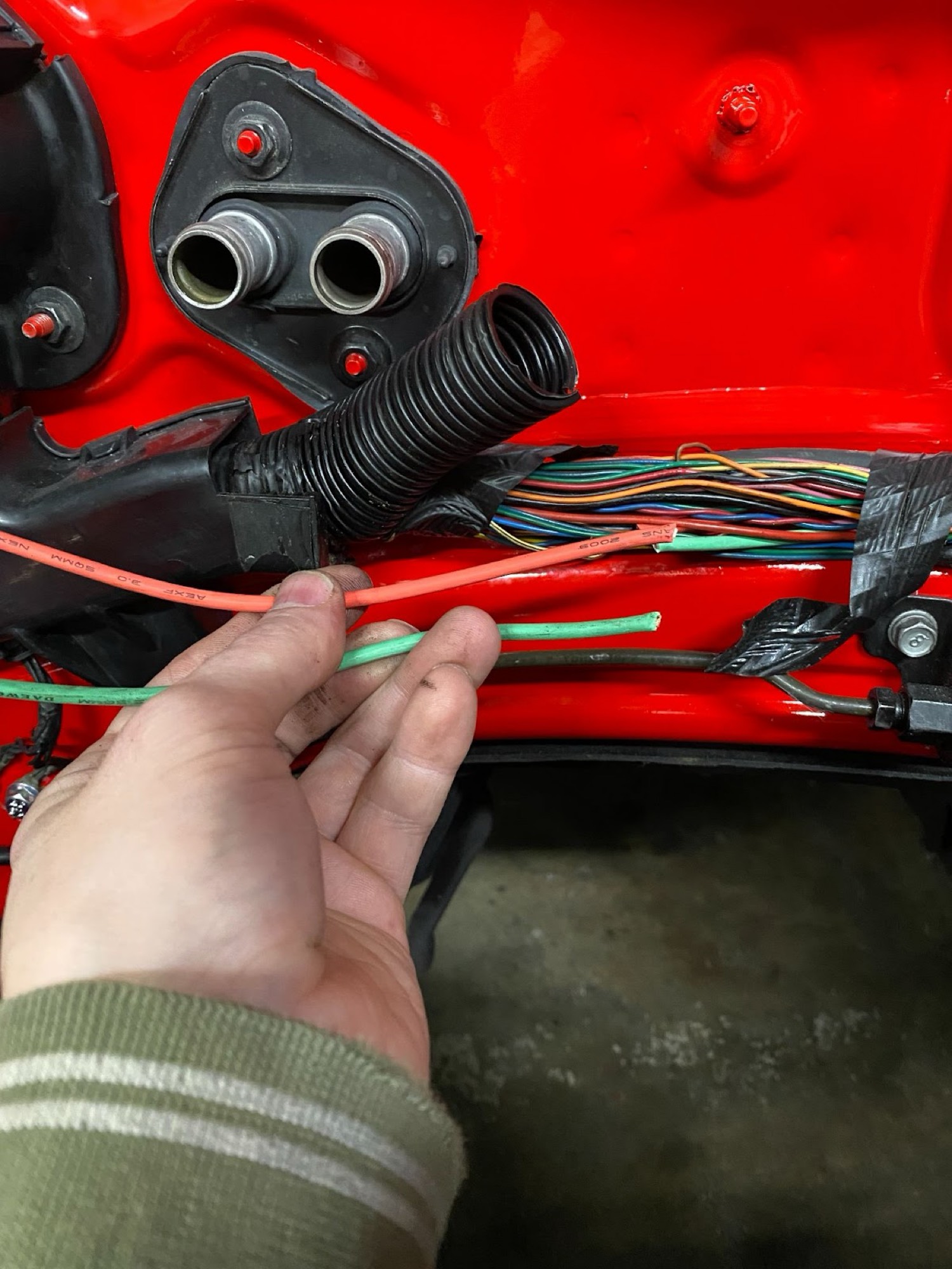 Orange and green factory fan wires at firewall bulkhead